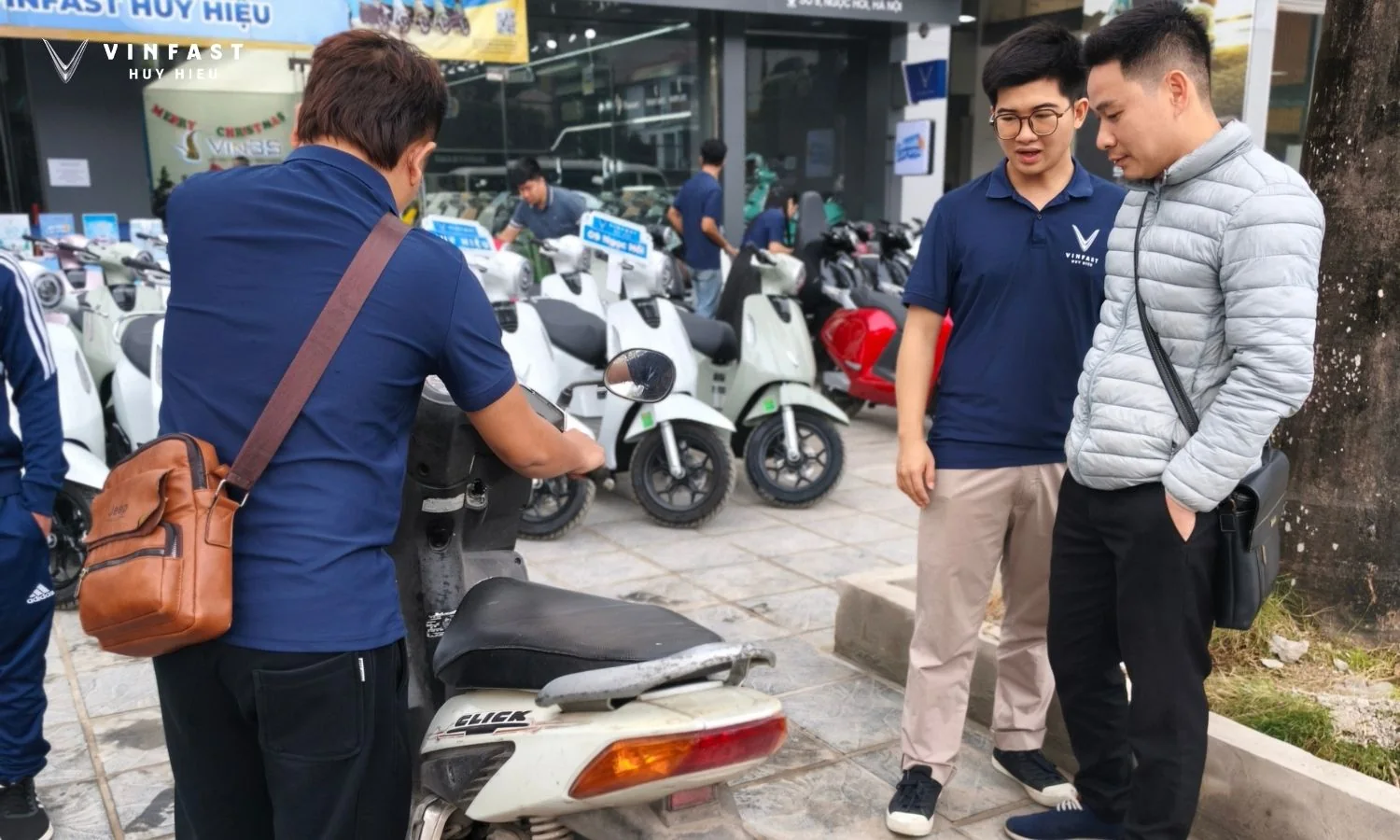 Nhân viên VinFast Huy Hiệu kiểm tra xe máy xăng của khách tại showroom